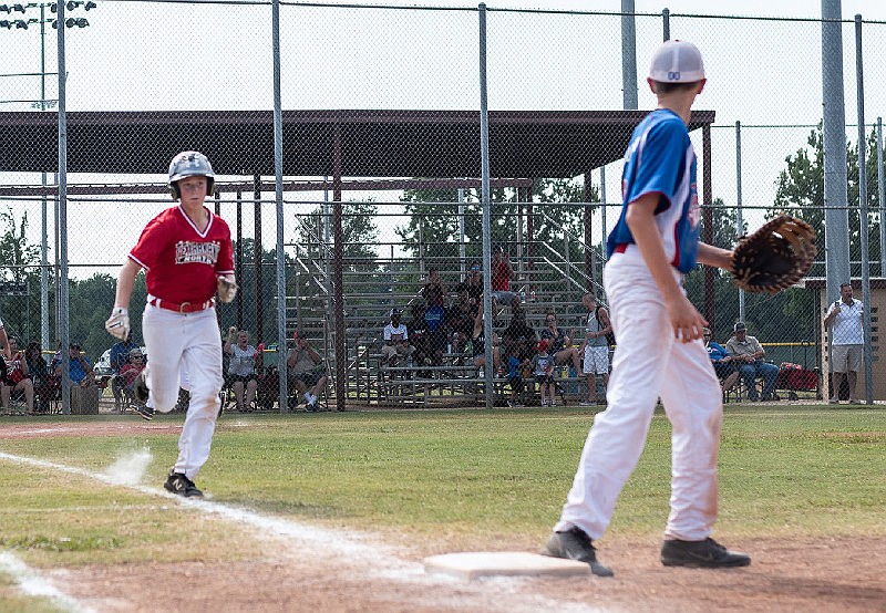 Brett Holt, a baseball player for the Texarkana, Texas Dixie 12u majors team, speeds to first base as a Nacogdoches player awaits the throw July 9, 2019. at Spring Lake Park. Dixie Youth Baseball is starting back up June 1 in Arkansas and Texas. (Submitted photo)
