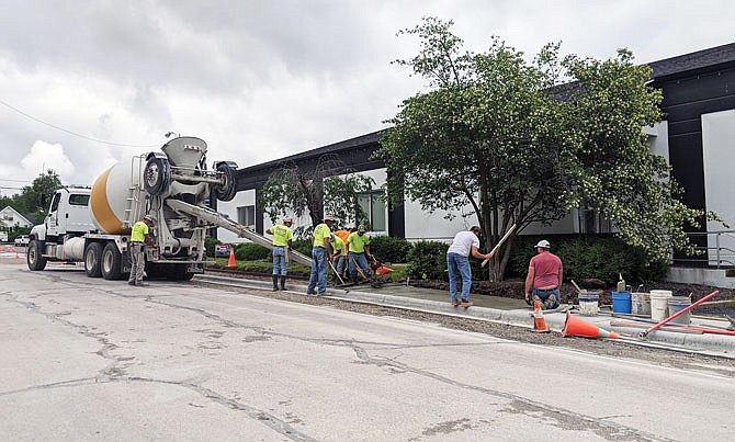 Workers pour and level concrete for sidewalks Wednesday along Jefferson Street near its intersection with Fifth Street. After many months of road work, Jefferson Street is getting a much-needed facelift.