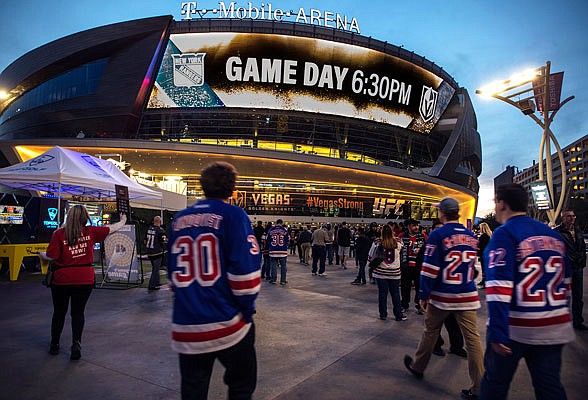 In this Jan. 7, 2018, file photo, Rangers fans arrive at T-Mobile Arena for a game between the Rangers and the Golden Knights in Las Vegas. T-Mobile Arena is one of the possible locations the NHL has zeroed in on to host playoff games if it can return amid the coronavirus pandemic.