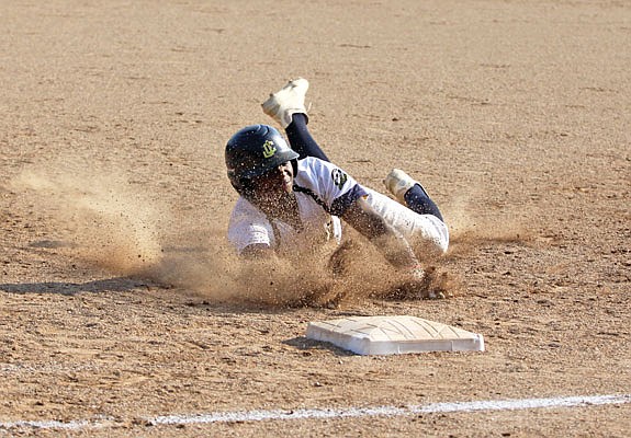 Dede Cole of the Renegades dives back into first base during a game against the Clarinda A's last season at Vivion Field.