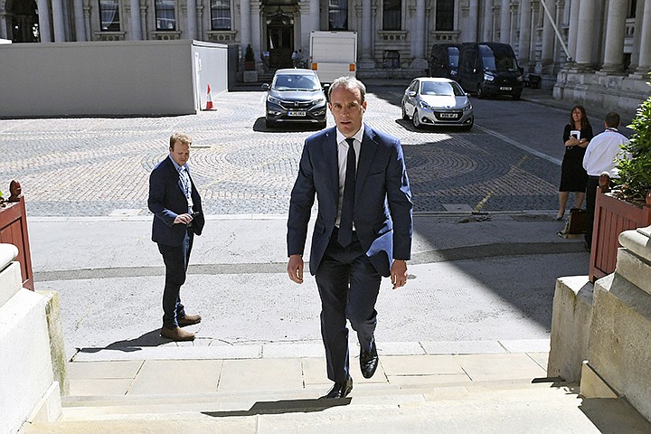 Britain's Foreign Secretary Dominic Raab arrives at the Foreign and Commonwealth Office in London, Thursday May 28, 2020. Raab has signed a joint statement urging China to work with the government of Hong Kong to find a "mutually acceptable accommodation that will honour China's international obligations" under the Joint Declaration. (Stefan Rousseau/PA via AP)