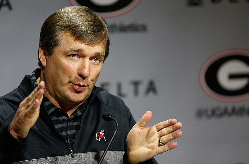 In this March 19, 2019, file photo, Georgia coach Kirby Smart speaks with the media on the first day of spring NCAA college football practice, in Athens, Ga. As he prepares to welcome his players back to campus, Georgia coach Kirby Smart says they'll be safer working out in supervised conditions but are free to stay away if they don't feel comfortable. He also urged fans to take necessary precautions against the coronavirus if they "want to have a football season." (Joshua L. Jones/Athens Banner-Herald via AP, File)