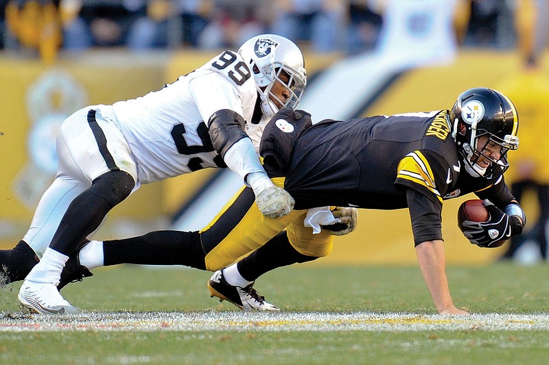 In this Nov. 8, 2015, file photo, Aldon Smith of the Raiders brings down Steelers quarterback Ben Roethlisberger during a game in Pittsburgh. 
