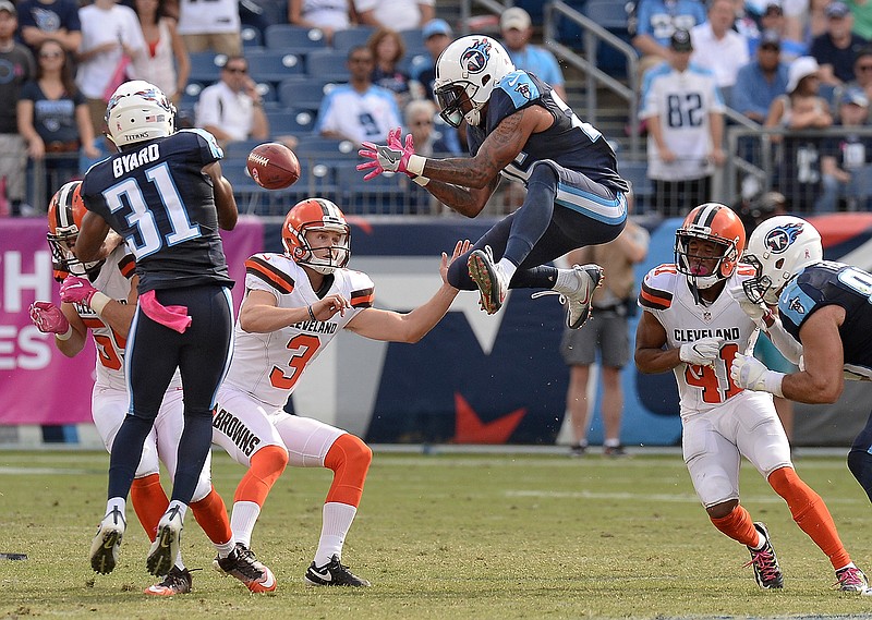 In this Oct. 16, 2016, file photo, Tennessee Titans' Rashad Johnson, center, and Kevin Byard (31) try to control an onside kick by Cleveland Browns' Cody Parkey (3) during the second half of an NFL football game in Nashville, Tenn. The Browns recovered the ball on the play. The NFL desperately is seeking ways to eliminate the more dangerous plays, and the onside kick has been deemed one. It occurs rarely, and in recent years with alterations to alignments and run-ups, the probably of it succeeding has plummeted. So Eagles owner Jeffrey Lurie suggested giving teams an alternative. They could still try the onside kick, or they could opt for a fourth-and-15 play from the kicking team's 25-yard line. (AP Photo/Mark Zaleski, File)