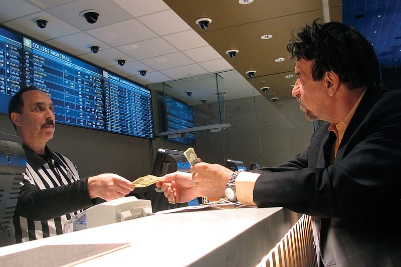 In this Jan. 29 file photo, a gambler makes bets on Super Bowl 54 at Bally's Casino in Atlantic City N.J. The coronavirus pandemic could lead to a quicker expansion of sports betting and internet gambling in the U.S. 