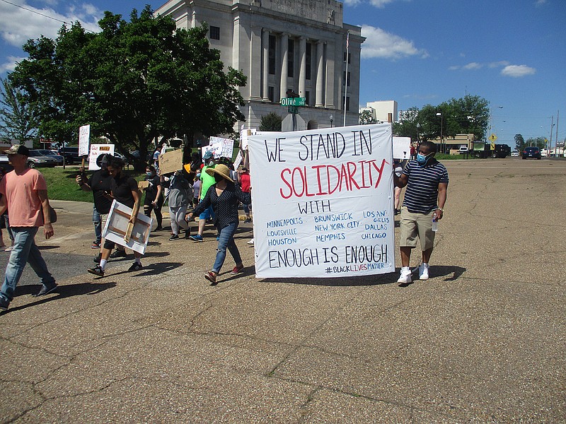 Demonstrators protesting the death of George Floy in Minnesota gather Saturday at the Downtown Post Office in Texarkana and march. Most of the group marched back to the post office before heading north down North State Line Avenue and ended up at a store parking lot at State Line Avenue and Arkansas Boulevard.