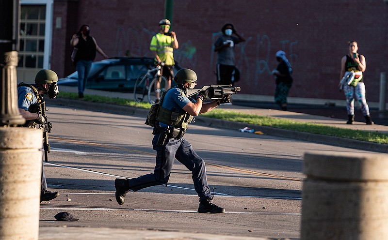 Police take control of the area near the Super Target against protesters Thursday, May 28, 2020, in St. Paul, Minn. Protests over the death of George Floyd, a black man who died in police custody, broke out in Minneapolis for a third straight night. (Richard Tsong-Taatarii/Star Tribune via AP)