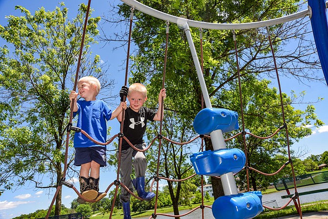 Bryce and Brock Boessen, 2 and 5 respectively, enjoyed playing on the newly reopened playground equipment at McKay Park. The Jefferson City Parks, Recreation and Forestry Department closed parks several weeks ago due to the coronavirus pandemic and reopened them Friday.