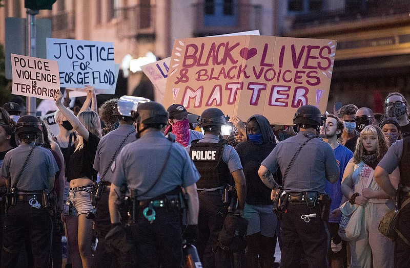 In this May 29, 2020, photo, police in protective gear held protesters back during a George Floyd protest at the Country Club Plaza in Kansas City. Protests have been erupting all over the country after George Floyd died earlier this week in police custody in Minneapolis. (Tammy Ljungblad/The Kansas City Star via AP)