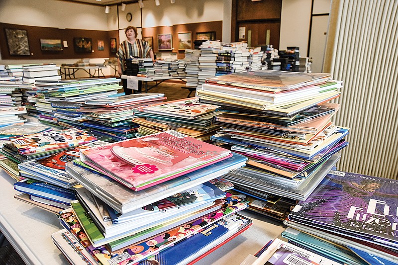 Missouri River Regional Library Director Claudia Cook walks through the stacks of books in the quarantine room in the gallery on the second floor of the downtown Jefferson City location.