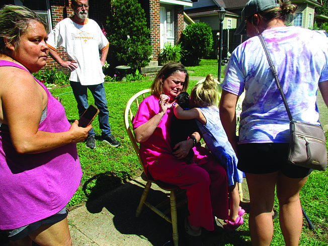 Texarkana, Texas, firefighters saved five dogs from a house fire Sunday afternoon in the 2900 block of Hazel Street. Pictured above, the dogs' owner attempts to comfort "Maggie," who was the last of of the pets to be pulled from the home.