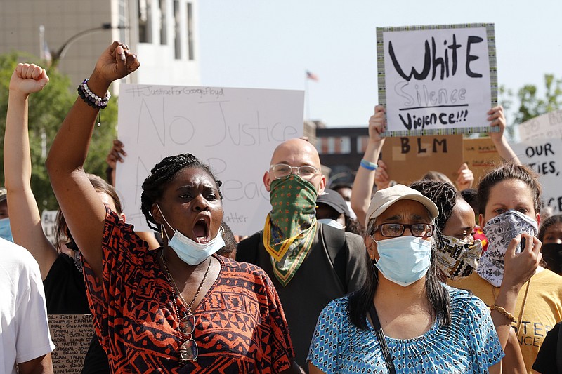 Protesters chant as they march in the street way from the City Justice Center Monday, June 1, 2020, in St. Louis. Protesters gathered to speak out against the death of George Floyd who died after being restrained by Minneapolis police officers on May 25. (AP Photo/Jeff Roberson)