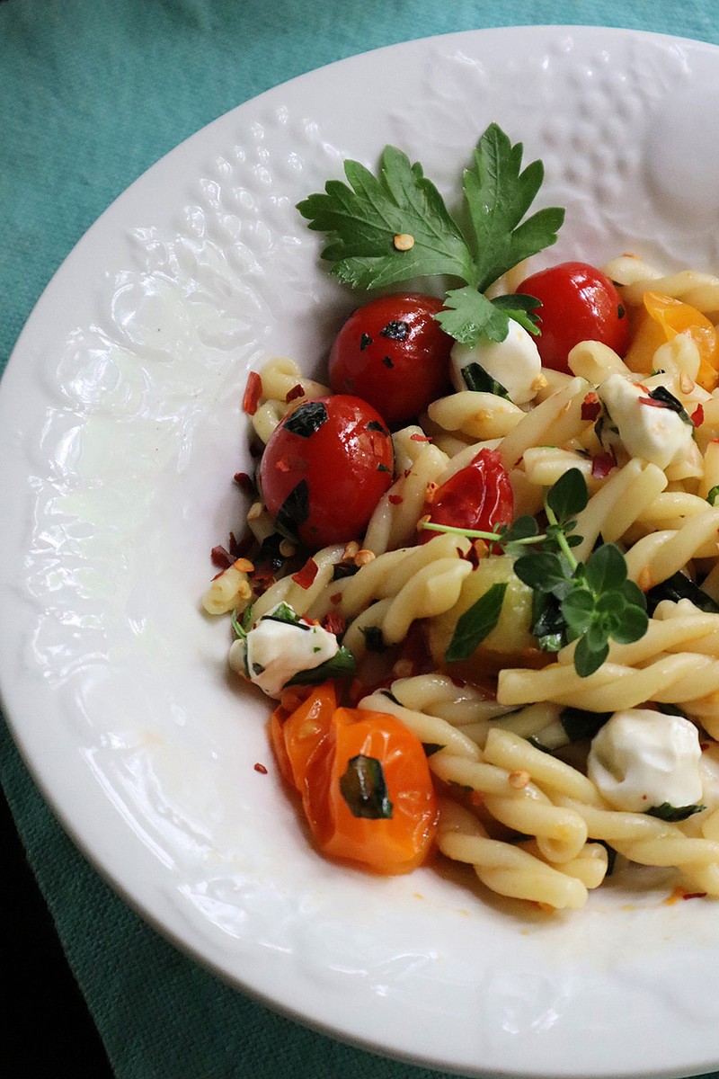 Five herbs you can easily grow in a kitchen garden brighten this simple pasta dish made with charred cherry tomatoes. (Gretchen McKay/Pittsburgh Post-Gazette/TNS)