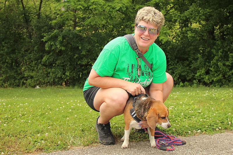 Theresa Oberlag poses with her dog, Bandit, while on a walk.