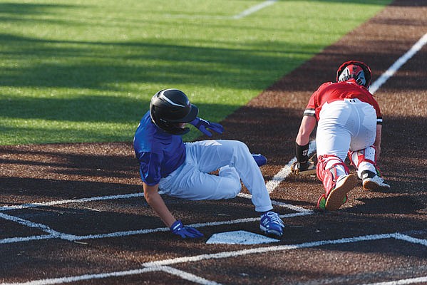 Taggert Bodenstab of Capital City scores on a double steal in the top of the first inning of Tuesday's first game of a doubleheader against Southern Boone in Ashland.