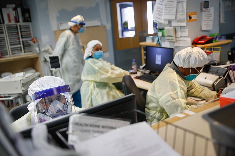 In this Monday, April 20, 2020 file photo, emergency room doctors and nurses wear personal protective equipment due to COVID-19 concerns at St. Joseph's Hospital in Yonkers, N.Y. On Wednesday, June 3, 2020, the Centers for Disease Control and Prevention released a study which found hospital emergency room visits from chest pain and heart attacks fell early this spring, further confirming experts' fears that U.S. coronavirus outbreaks scared away many heart patients from going to ERs who should have gone. (AP Photo/John Minchillo)