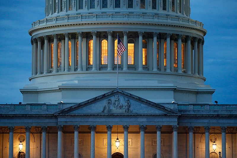 In this May 3, 2020, file photo, light shines from inside the U.S. Capitol dome at dusk on Capitol Hill in Washington. (AP Photo/Patrick Semansky)