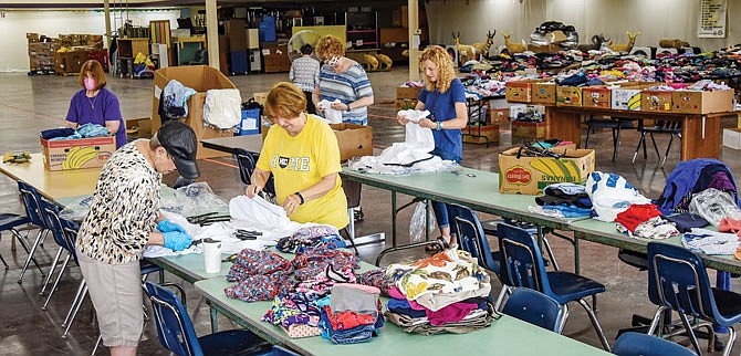 Volunteers and staff from The Samaritan Center have been sorting clothing for next week's giveaway. The center still had winter clothing in stock when the pandemic hit and then the spring/summer clothing donations started to accrue — too much to keep on hand at the agency. Clothes are being sorted into tubs and boxes and onto tables which will be set outside and refilled from said boxes and tubs and the clothing is picked up. The giveaway is a cooperative effort between Immaculate Conception Catholic Church and The Samaritan Center to make sure center clients have summer clothing.