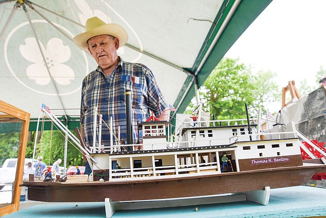 Larry Languell, of Tebbetts, talks about how he made the replica paddle wheel boat, Thomas Hart Benton, seen in the case. He brought several handmade boats for display at Friday's Cole County Bicentennial celebration kickoff at the Missouri River access in Marion. 