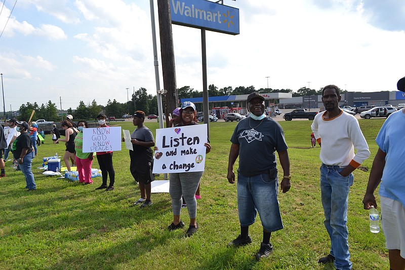 Approximately two dozen people showed up for the Protest Rally in front of the Atlanta Wal Mart on Loop 59.