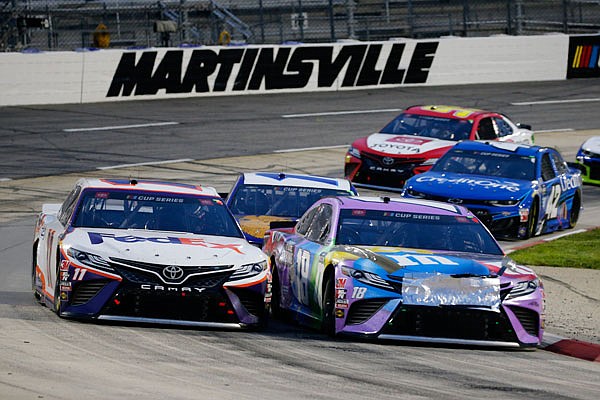 Denny Hamlin (left) and Kyle Busch drive through a turn during Wednesday night's NASCAR Cup Series race in Martinsville, Va.