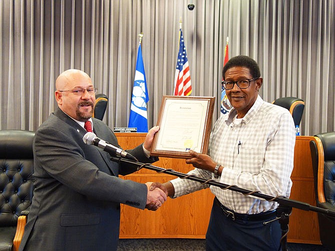 Fulton Mayor Lowe Cannell, left, read a proclamation Tuesday night recognizing former City Council member Steve Moore for his 36 years of service to the city.