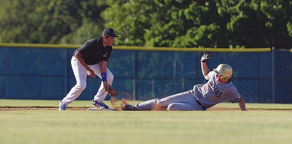 Capital City second baseman Carlos Ayala forces out Helias' Nick Heislen in the bottom of the second inning of Thursday's first game at the American Legion Post 5 Sports Complex.