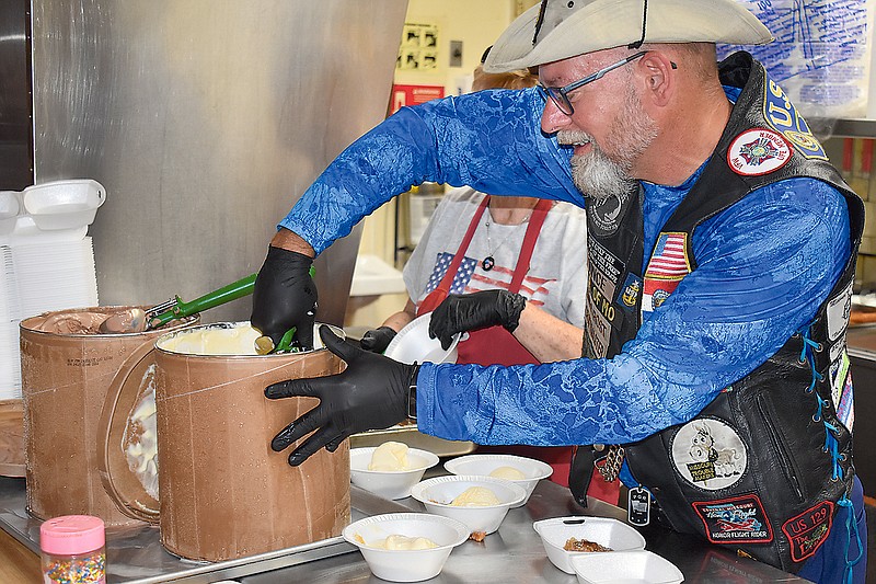 Vince Rost, former American Legion Post 5 commander, scoops ice cream at Sunday's annual Flag Retirement Ceremony at the American Legion.