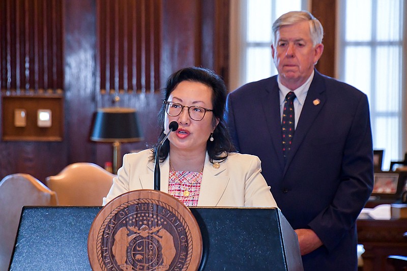 Anna Hui, director of the Missouri Department of Labor and Industrial Relations, speaks Tuesday during a COVID-19 briefing as Gov. Mike Parson looks on.