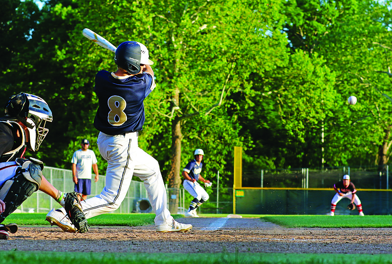 Alex Loethen of Helias smacks a ground ball that drove in the go-ahead run during the seventh inning of Tuesday's first game of a doubleheader against Jefferson City at Vivion Field.