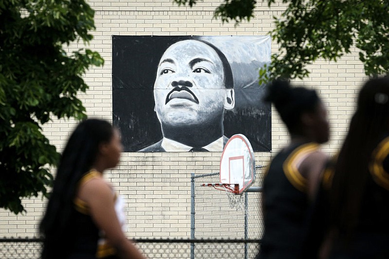 The parade passes by a painting of Martin Luther King Jr. during the 48th Annual Juneteenth Day Festival on June 19, 2019 in Milwaukee, Wisconsin. (Photo by Dylan Buell/Getty Images for VIBE/TNS)