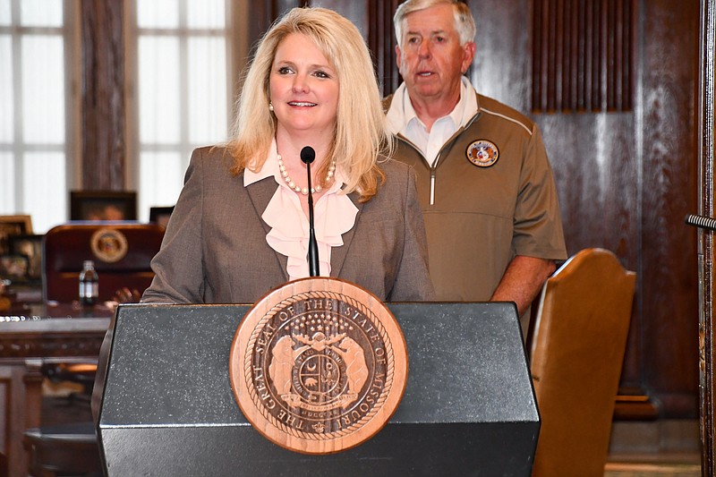 Missouri Department of Agriculture Director Chris Chinn speaks during a COVID-19 briefing Thursday, June 18, 2020, as Gov. Mike Parson looks on.