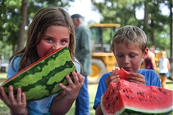 Collins and Grayson McMoran eat watermelons Aug. 10, 2019, during the Hope Watermelon Festival in Hope, Arkansas. (Staff file photo)
