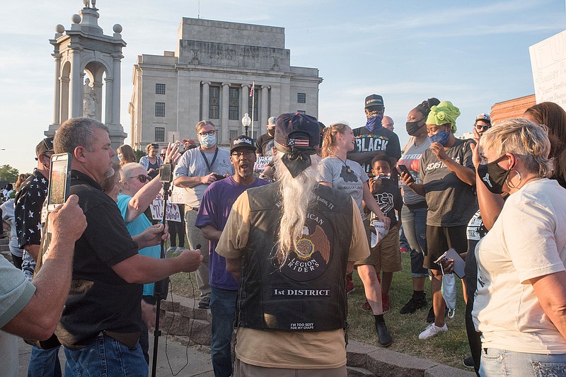 A group of protesters and counterprotesters meet at the Confederate monument in downtown Texarkana. A demonstration in favor of removing the monument was met by counterprotesters, and about 100 people gathered to express themselves, often angrily trying to shout one another down.