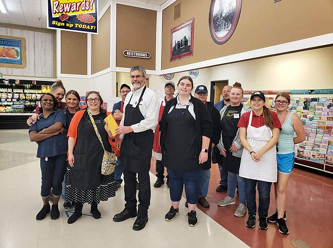 Members of the C&R Market team — including manager Jay Hickman, holding envelope — saved tips and delivery fees to donate to the Callaway Senior Center. The funds will help feed hungry seniors in the community, CSC Administrator April Redman said.