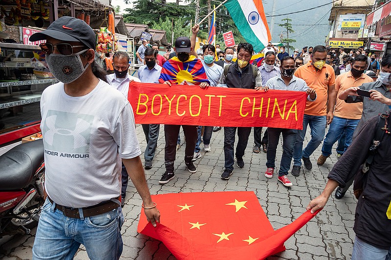 Exile Tibetans and local Indians participate in a protest against the Chinese government in Dharmsala, India, Friday, June 19, 2020. India said Thursday it was using diplomatic channels with China to de-escalate a military standoff in a remote Himalayan border region where 20 Indian soldiers were killed this week. (AP Photo/Ashwini Bhatia)