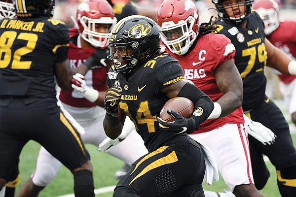 In this Nov. 29, 2019, file photo, Missouri running back Larry Rountree III finds a hole in the Arkansas defense as he runs the ball during a game in Little Rock, Ark.