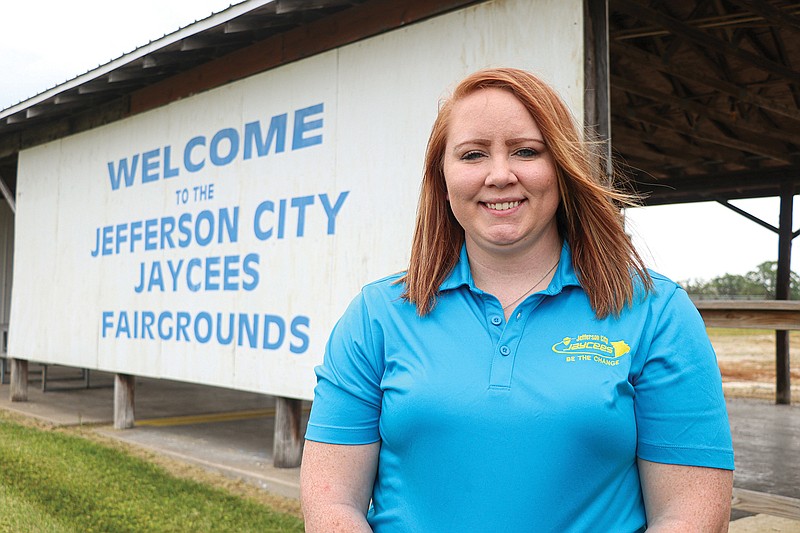Chelsea Hite poses in front of the Jefferson City Jaycees Fairgrounds sign Friday afternoon. Hite is the 2020 chapter president of the Jefferson City Jaycees. Hite said the Jefferson City Jaycees Cole County Fair will remain on schedule this year, opening on July 27.