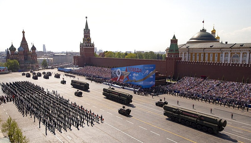 In this Tuesday, May 7, 2019 file photo, Russian military vehicles roll down Red Square Red Square during a rehearsal for the Victory Day military parade in Moscow, Russia. A massive military parade that was postponed by the coronavirus will roll through Red Square this week to celebrate the 75th anniversary of the end of World War II in Europe, even though Russia is continuing to register a steady rise in infections. (AP Photo/Alexander Zemlianichenko, Pool, File)