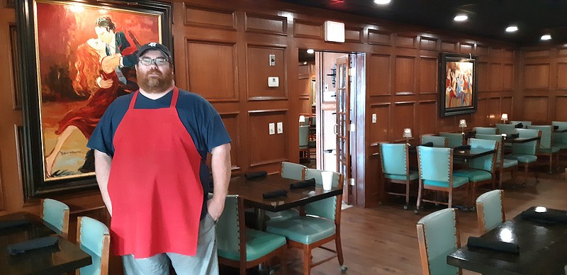 Cattleman's owner Cash Oliver shows off the refurbished dining room, most notably the floor tiling and the ceiling lights. Oliver wanted to make sure things were all ready to go before they let in the customers.
