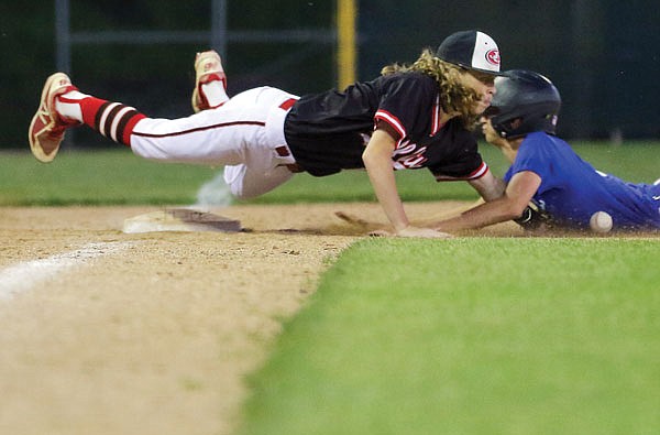 Jefferson City third baseman Brayden Whittle dives for a loose ball to try to tag Capital City baserunner Preston Pinet during Tuesday night's doubleheader at Vivion Field.
