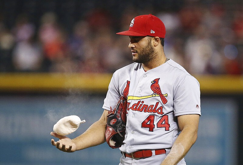 In this Sept. 25, 2019, file photo, St. Louis Cardinals relief pitcher Junior Fernandez flips the rosin bag during the sixth inning of the team's baseball game against the Arizona Diamondbacks in Phoenix.