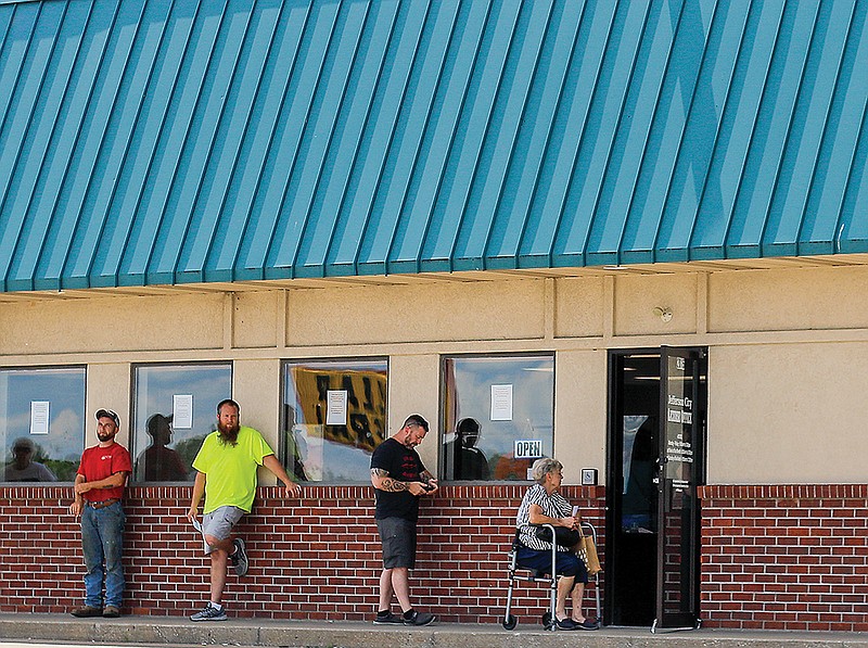 People stand in line Wednesday, June 24, 2020, outside the Jefferson City Licensing Office.