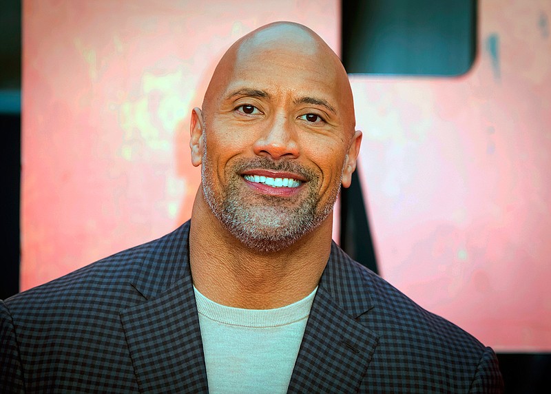 In this April 11, 2018, file photo, actor Dwayne Johnson poses for photographers at the premiere of the "Rampage," in London. Johnson will host and Justin Bieber, Miley Cyrus and Jennifer Hudson will perform on a globally broadcast concert calling on world leaders to make coronavirus tests and treatment available and equitable for all. The advocacy organization Global Citizen and the European Commission announced Monday, June 22, 2020 that Global Goal: Unite for Our Future — The Concert will air on June 27. (Photo by Vianney Le Caer/Invision/AP, File)