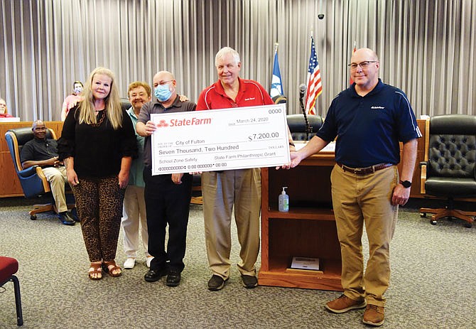 A grant from State Farm will sponsor the installation of two radar speed limit signs on Wood Street. Bush Elementary School Principal Holly Broadway, left, former council member Beverly Gray, Mayor Lowe Cannell and State Farm agents Don Woodson and Russ Weyland were on hand Tuesday for a check presentation.