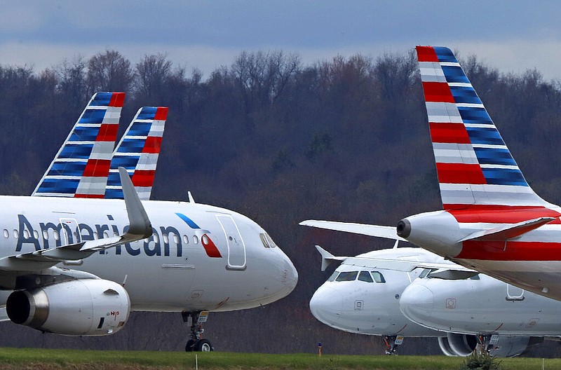 In this March 31, 2020 file photo American Airlines planes are parked at Pittsburgh International Airport in Imperial, Pa. (AP Photo/Gene J. Puskar, file)