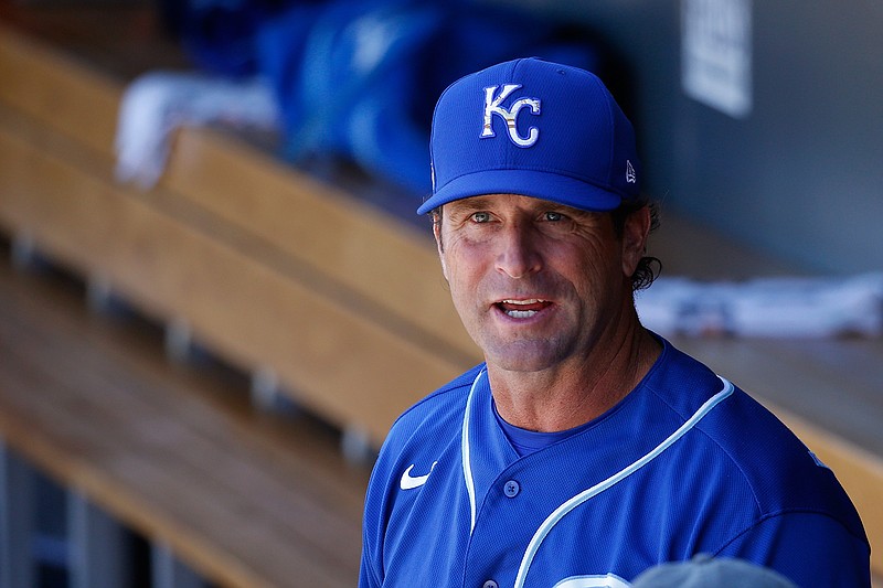 In this March 9, 2020, file photo, Kansas City Royals manager Mike Matheny pauses in the dugout prior to a spring training baseball game against the Arizona Diamondbacks in Scottsdale, Ariz. Forget about those halcyon first few days of spring training, when arranging for the right tee time on the right golf course is often more challenging than the work on the field. When major leaguers report next week for spring training 2.0 — or perhaps more accurately, baseball's first summer camp — time will be one precious commodity with about three weeks before opening day. "We're going to have some live batting practices the first day they show up. Day 1 and Day 2. ... Multiple ups for the starters," Matheny said Friday, June 26, 2020, on a video conference call. "These guys are prepared for that. They've been hungry for it." (AP Photo/Ross D. Franklin, File)