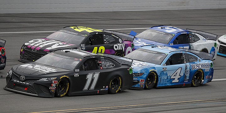 Denny Hamlin (11) takes the inside lane in front of Kevin Harvick (4) as Jimmie Johnson (48) keeps up during a NASCAR Cup Series auto race at Talladega Superspeedway in Talladega Ala., Monday, June 22, 2020. (AP Photo/John Bazemore)