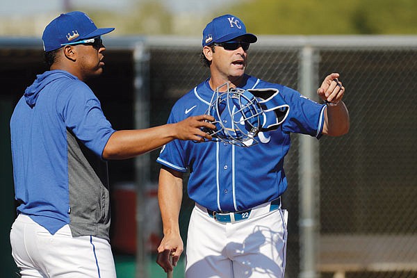 In this Feb. 17 file photo, Royals manager Mike Matheny talks to catcher Salvador Perez during spring training in Surprise, Ariz.