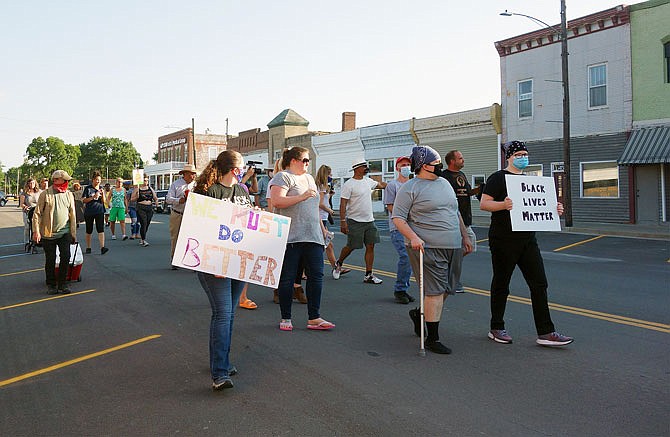 Protesters walk Friday through downtown Auxvasse during the march. Their demands for city officials included the removal or resignation of Police Chief Kevin Suedmeyer and the development of social media guidelines for city employees.